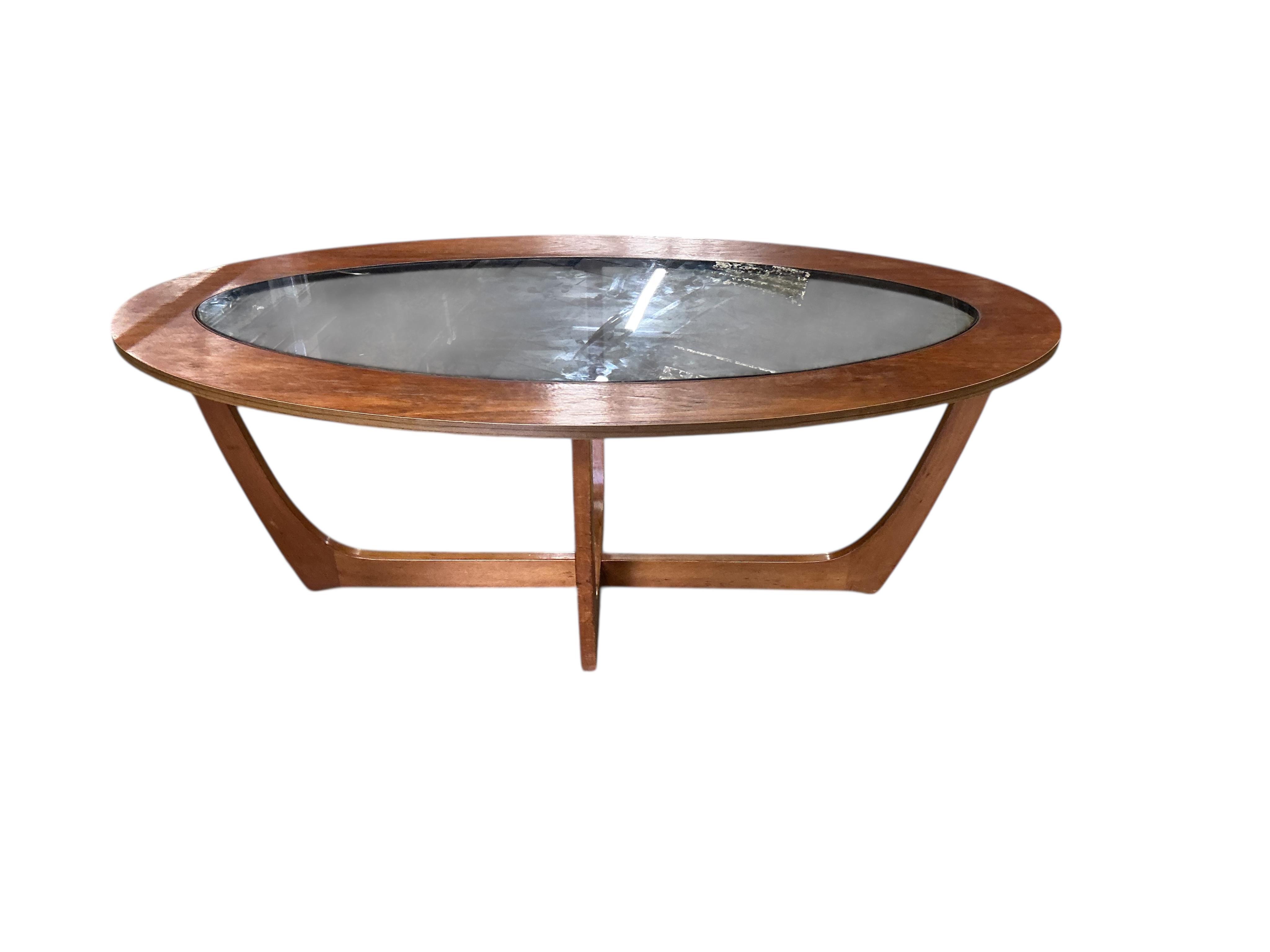 A mid century teak oval glass top coffee table, width 106cm, depth 53cm, height 41cm